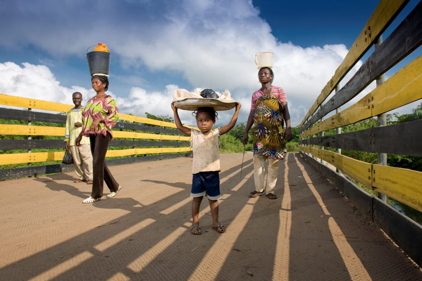 Community members crossing a river bridge, Obuasi, Ghana